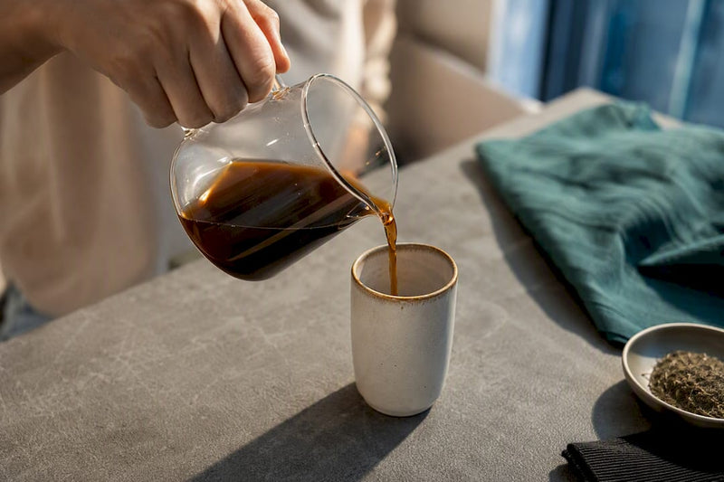 Small coffee serving beside microdosing materials